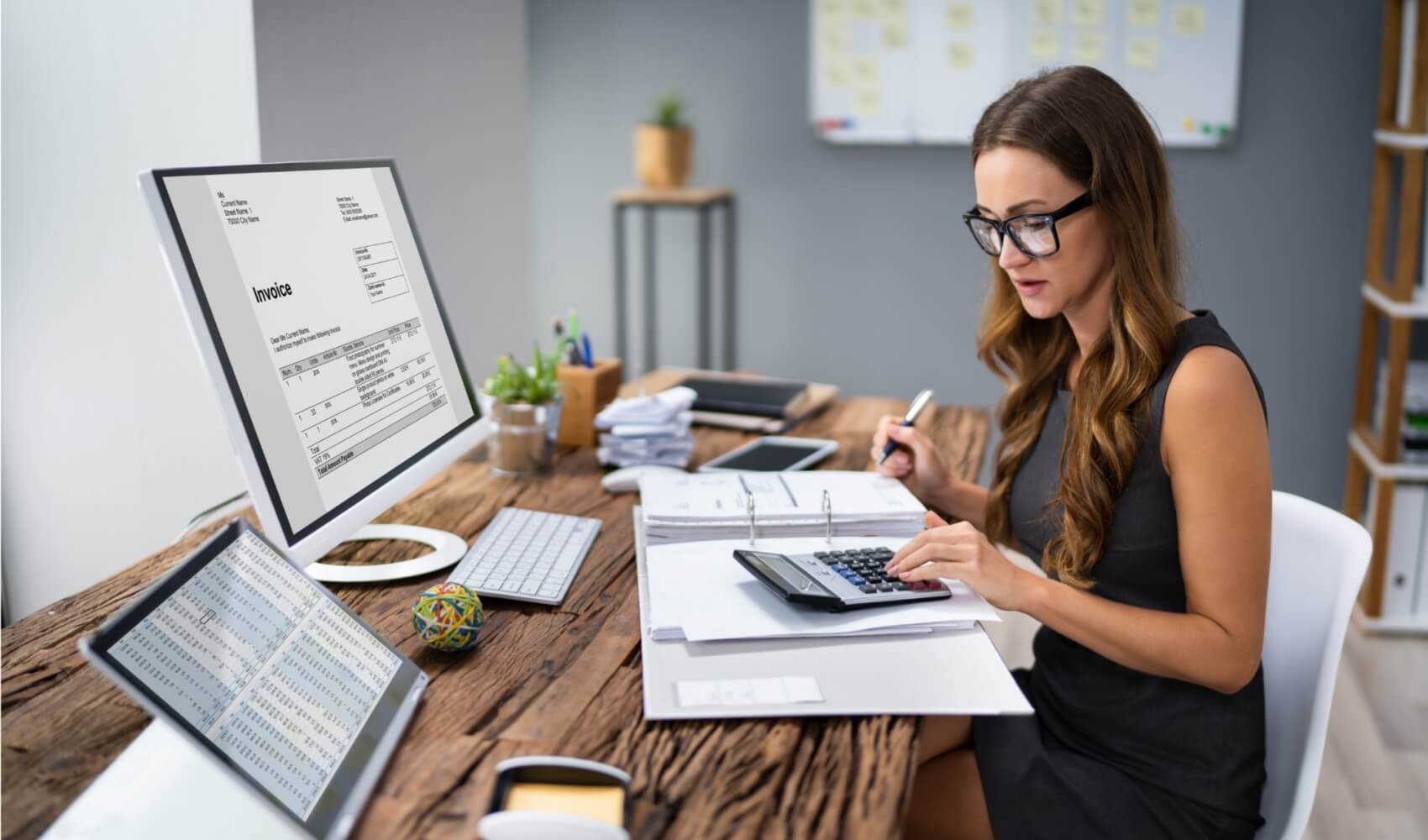 Woman with the calculator working with documents