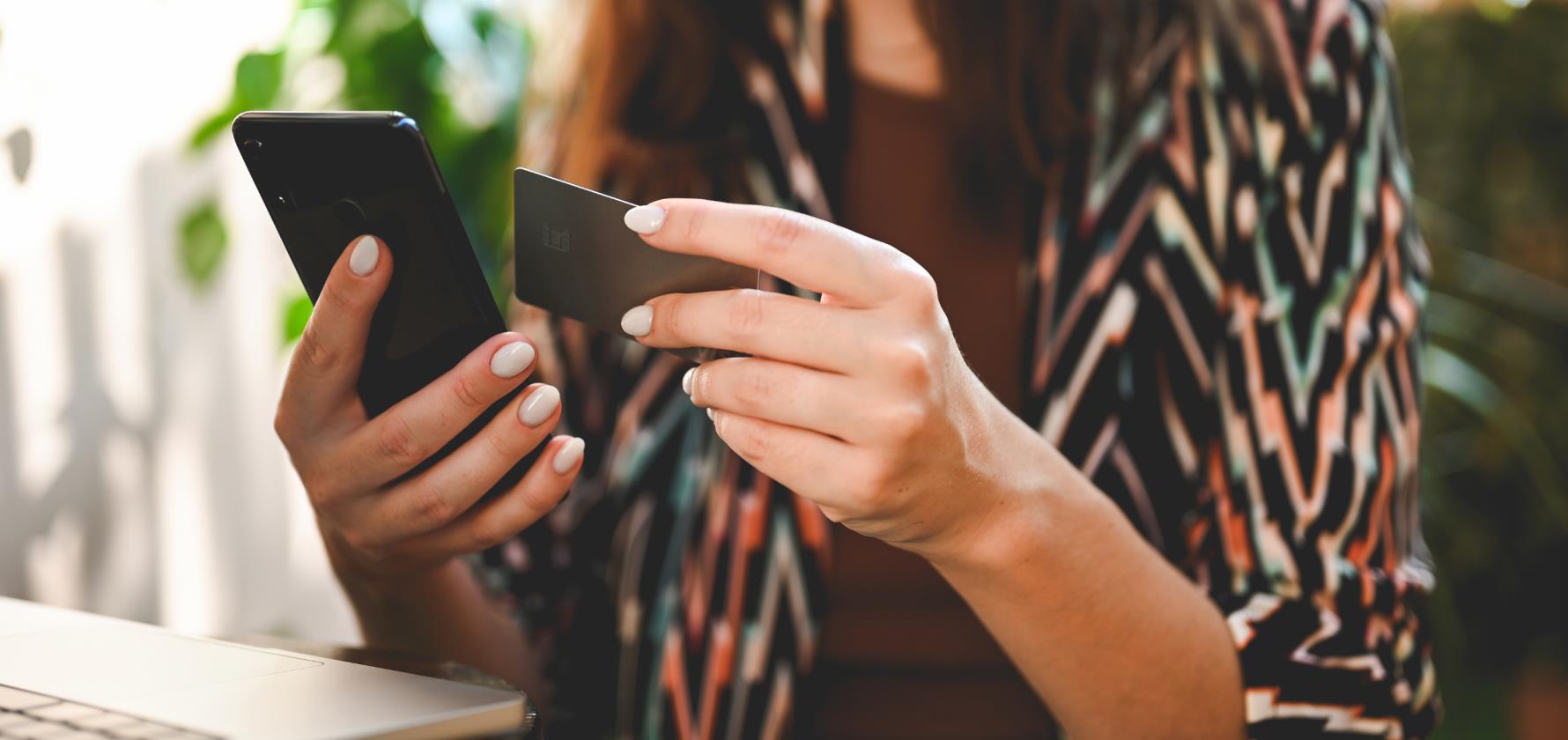 Woman pays with a credit card for online shopping